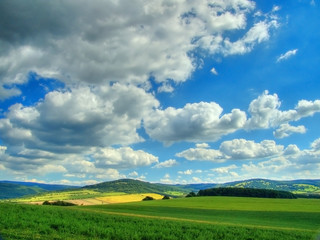 Obraz premium Clouds over the meadows
