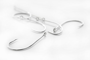 fishing hooks over white background