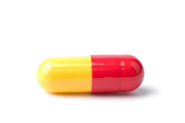 macro of red and yellow capsule pill isolated