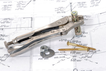 Lock grip pliers over house plan