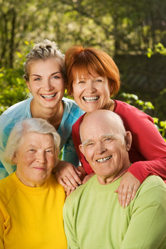 Senior couple with their daughter and granddaughter outdoors
