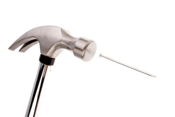 Hammer and nail over white