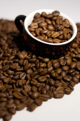 Coffee beans in the cup. Isolated on white background