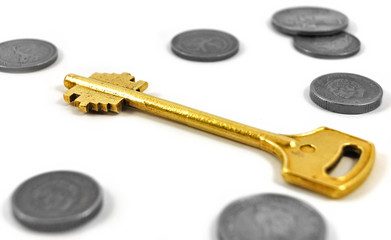 Golden key with coins symbolizing secure investment