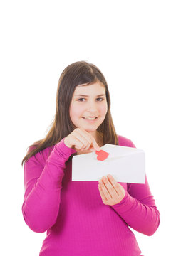 Teen girl taking valentine out of envelope