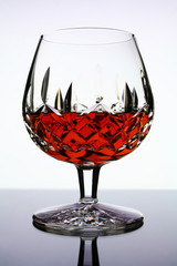 glass of cognac on white background