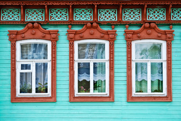 Three windows with carved wooden cases