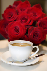 cup of coffee with fresh roses
