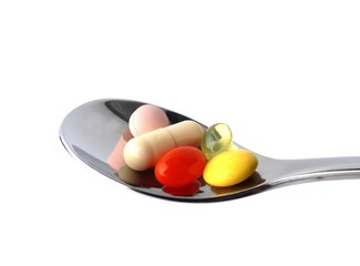 Fototapeta premium Colorful pills on spoon
