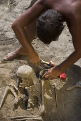 Archaeologist excavating prehistoric grave
