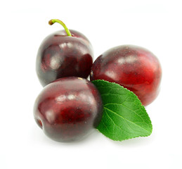 fresh plum fruits with green leaf isolated