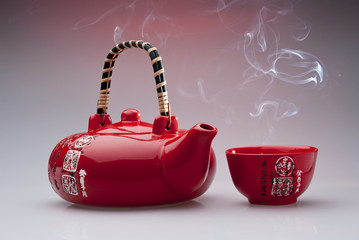 Chinese teapot with steaming cup