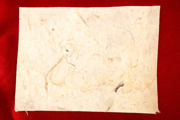 Old piece of paper on red background