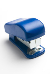 Blue stapler on white background.