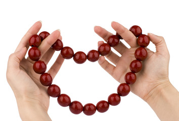 Red beads in hands, Gift to Valentines Day