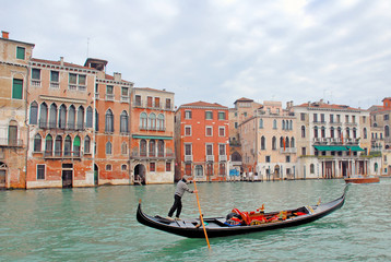 Fototapeta na wymiar Italy,Venice gondola in the grand canal at sunset