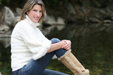 Obraz premium Gorgeous Woman in White Sweater at a Lake
