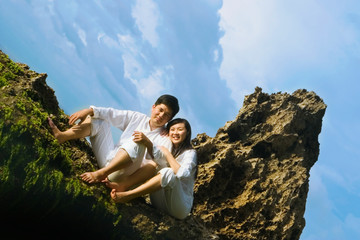 Young Couple On The Beach Rock
