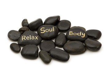 black spa massage stones on white background