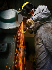 Tradesman at work grinding steel. - 11625987