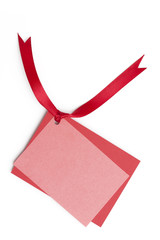 red gift bow and blank card on white background