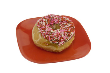 donut with sprinkles on a red plate