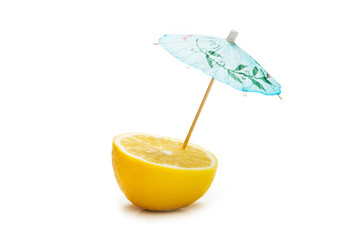 Lemon and umbrella isolated on the white