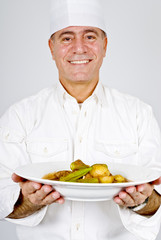 Chef Holding a Plate of Beef Stew