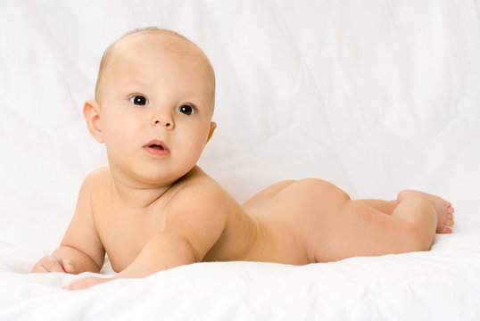 cute four months old baby on the white sofa
