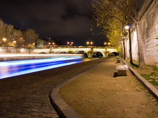 Fly-boat cruising on the river Seine by night.