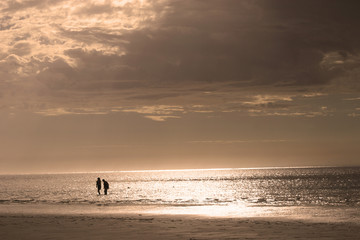 Fototapeta na wymiar Retired couple on beach at Sunset