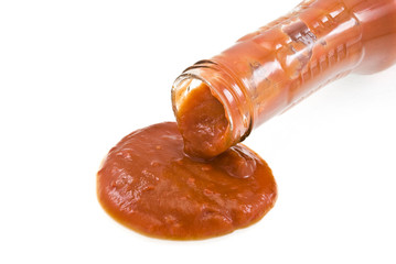 ketchup spilling from open glass bottle