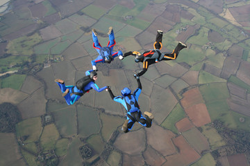 Four skydivers in a star formation