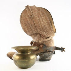 Old rodeo boot and a spittoon