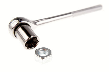 Wrench and nut isolated over white