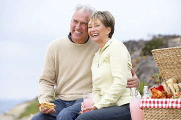 Couple Eating An Al Fresco Meal At The Beach