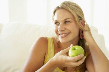 Mid Adult Woman Eating A Healthy Apple
