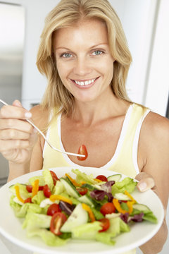 Mid Adult Woman Eating A Healthy Salad