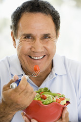 Senior Man Eating A Fresh Green Salad