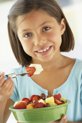 Girl Eating A Bowl Of Fresh Fruit Salad