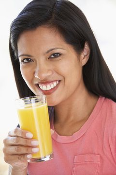 Mid Adult Woman Drinking Fresh Orange Juice