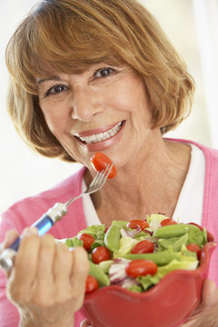 Middle Aged Woman Eating A Fresh Green Salad