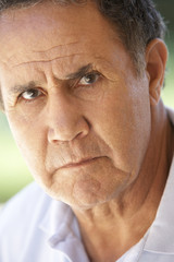 Portrait Of Senior Man Frowning At The Camera