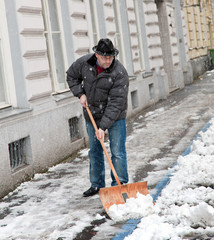 Hauswart räumt Gehsteig von Schnee