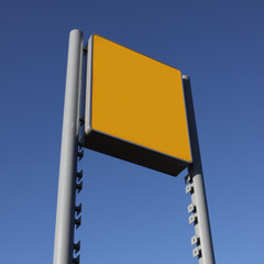 blank yellow sign against sky