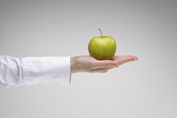 Woman's hand holding an apple