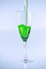 Green liquid drink being poured