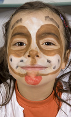 Young girl with a painted dog on her face