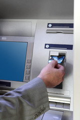 hand inserting card into cash dispense