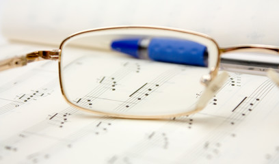 Glasses and pencil on book of notes